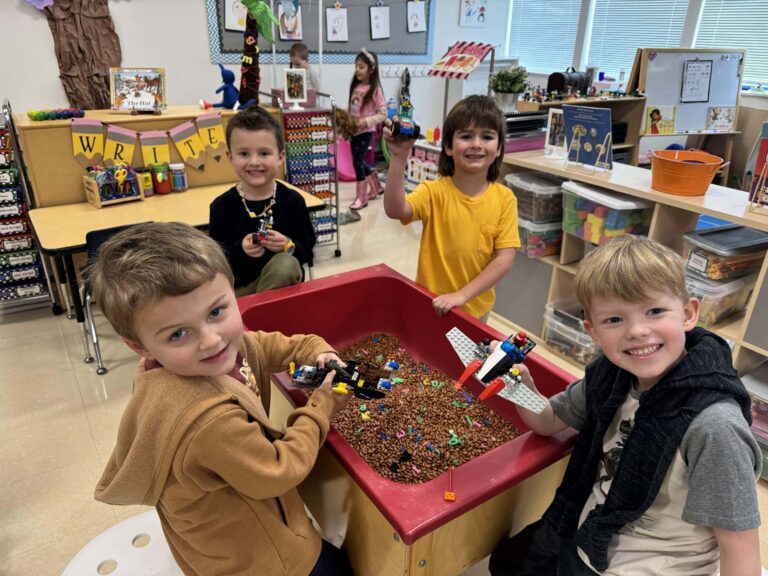 Four Preschool boys build at lego table at West Hills Christian School.