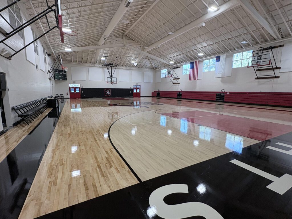West Hills Christian School gymnasium with polished wood floors and basketball hoops.